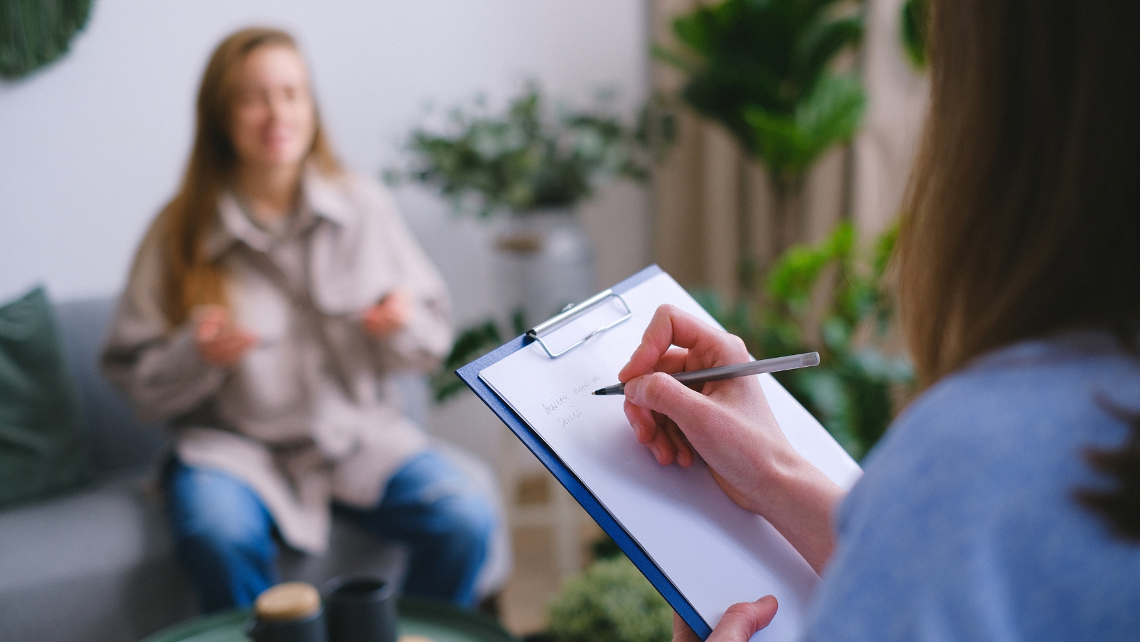 Patient sitting across from a mental health professional, asking questions during a psychiatric appointmen