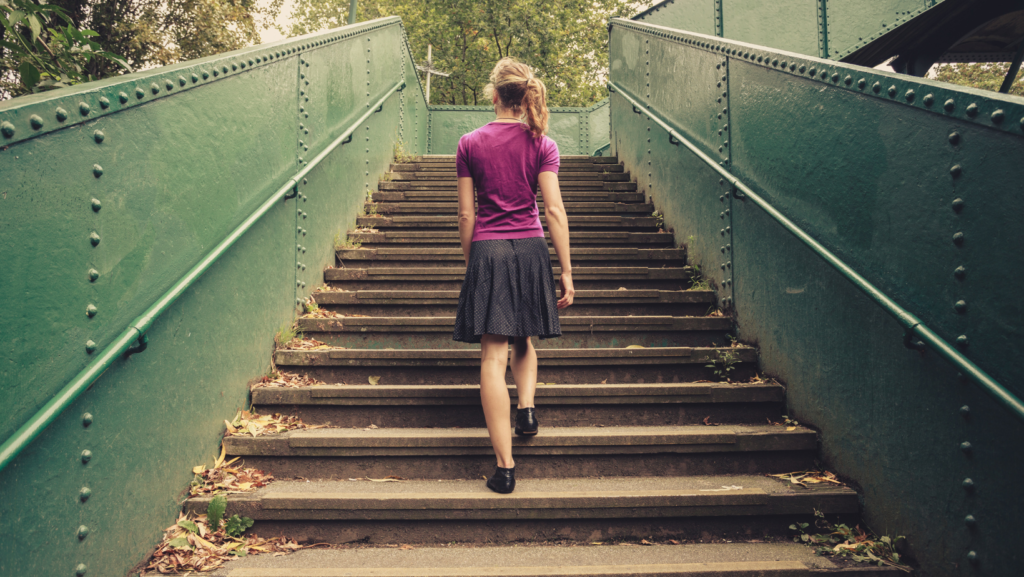 Image of a person walking uphill, symbolizing personal growth and resilience in mental health recovery