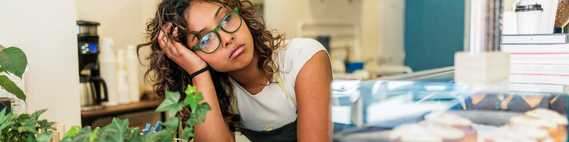 Woman feeling mentally exhausted and struggling with motivation and task initiation at work.